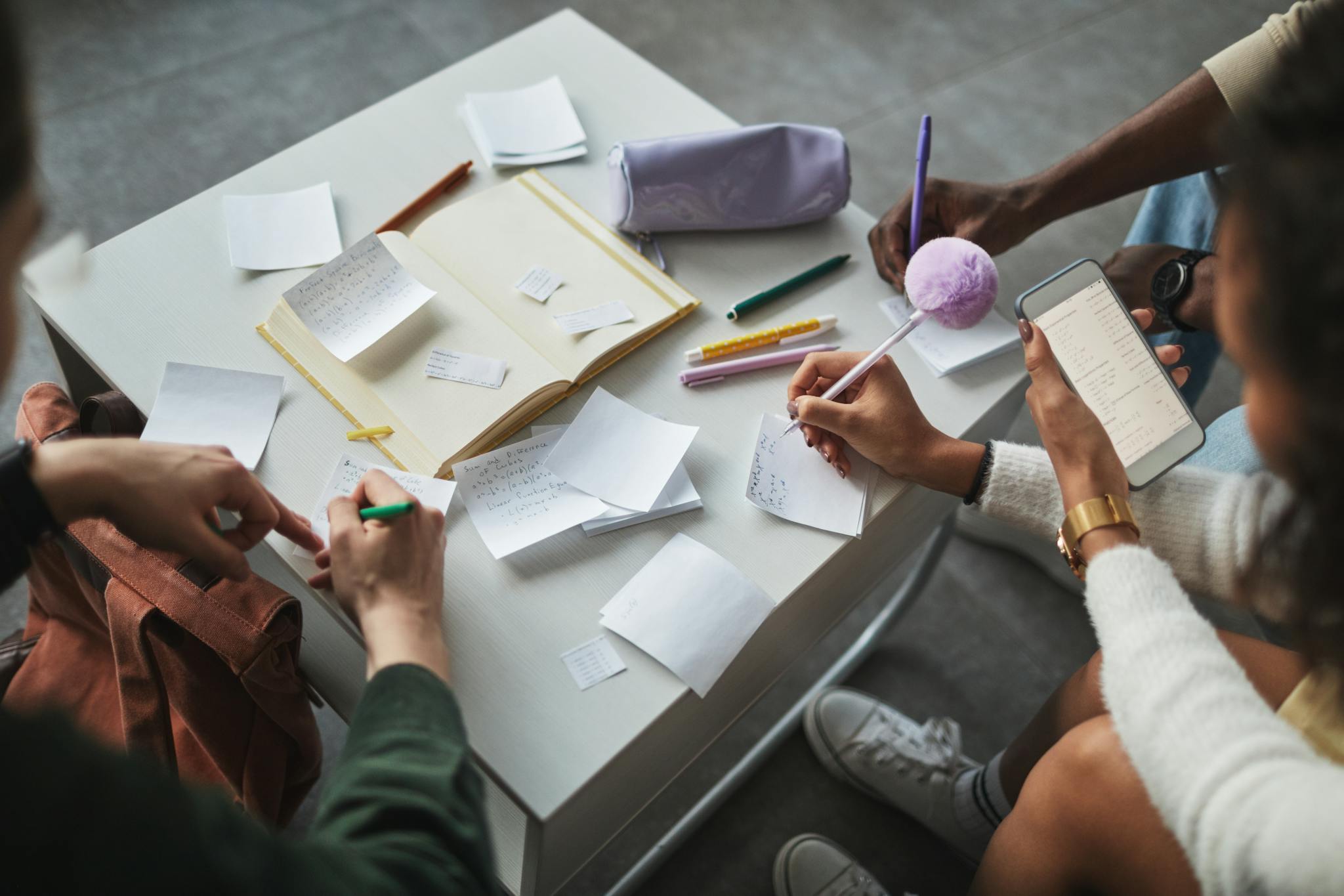 Groups of People Writing Notes on Papers